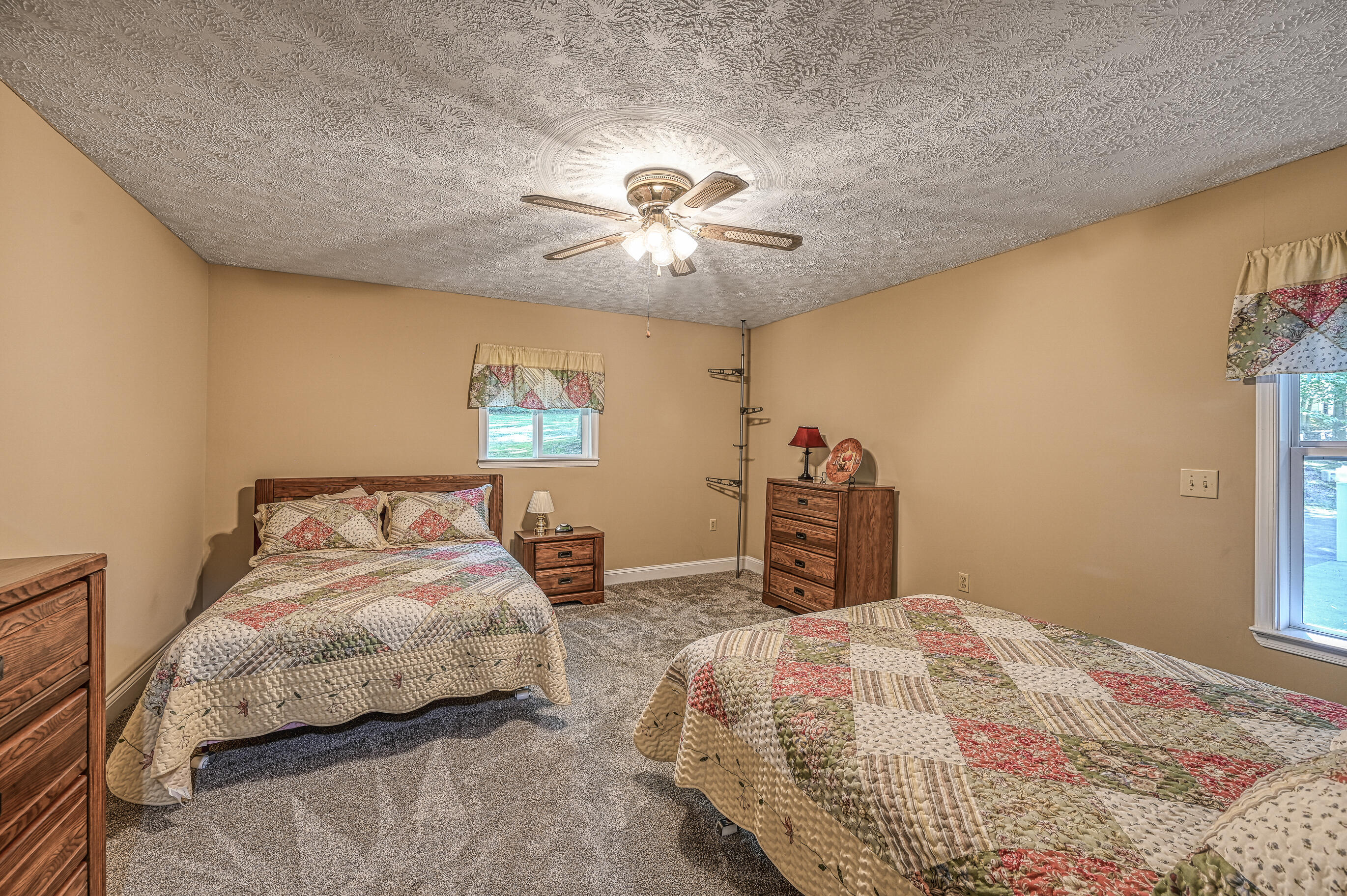 206 Oak Road Bumpass, VA 23024 - Photo 18 of 38 a bedroom with a bed and a chandelier