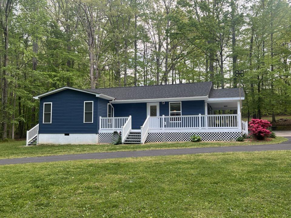 206 Oak Road Bumpass, VA 23024 - Photo 2 of 38 a front view of a house with a garden and trees