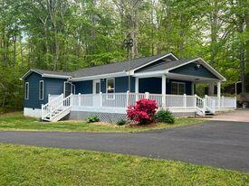 206 Oak Road Bumpass, VA 23024 - Photo 3 of 38 a front view of a house with a garden and porch