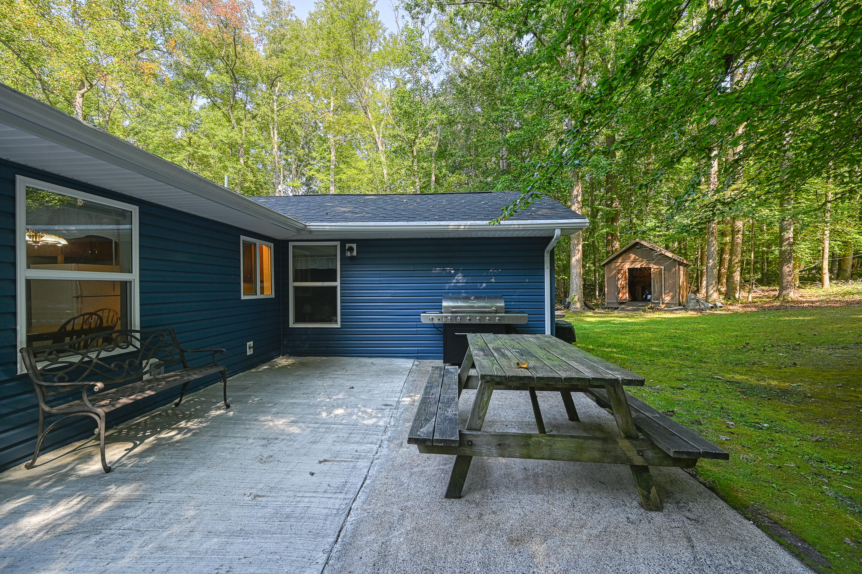 206 Oak Road Bumpass, VA 23024 - Photo 5 of 38 a view of a backyard with furniture and a fire pit