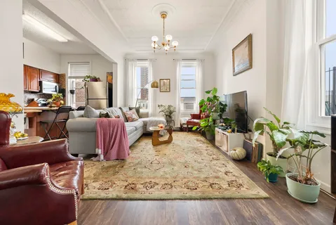 a living room with furniture windows and a chandelier