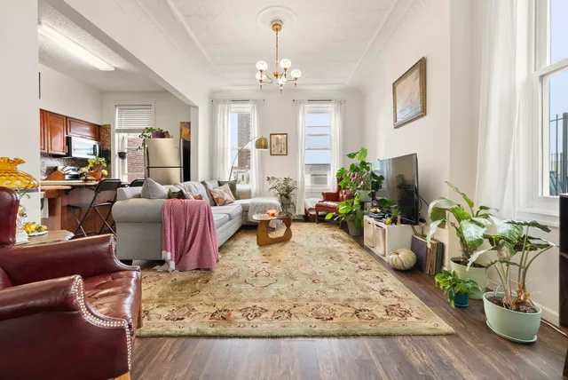 a living room with furniture windows and a chandelier