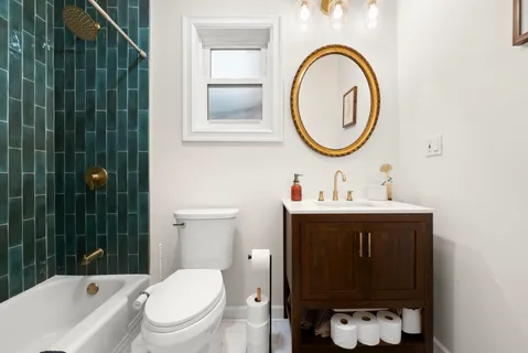 a bathroom with a sink a toilet and a mirror