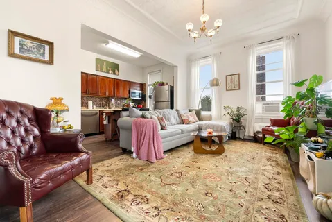 a living room with furniture fireplace and a potted plant