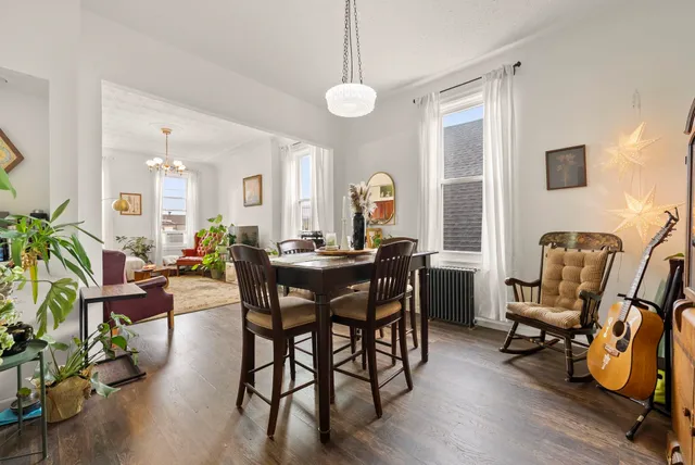 a view of a a dining room with furniture window and wooden floor