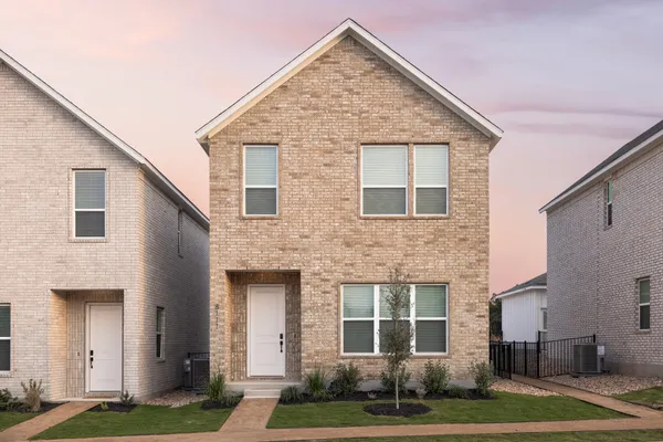 a kitchen with stainless steel appliances a table chairs refrigerator and sink