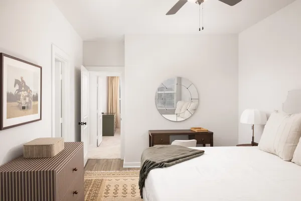 a living room with furniture a rug and a window