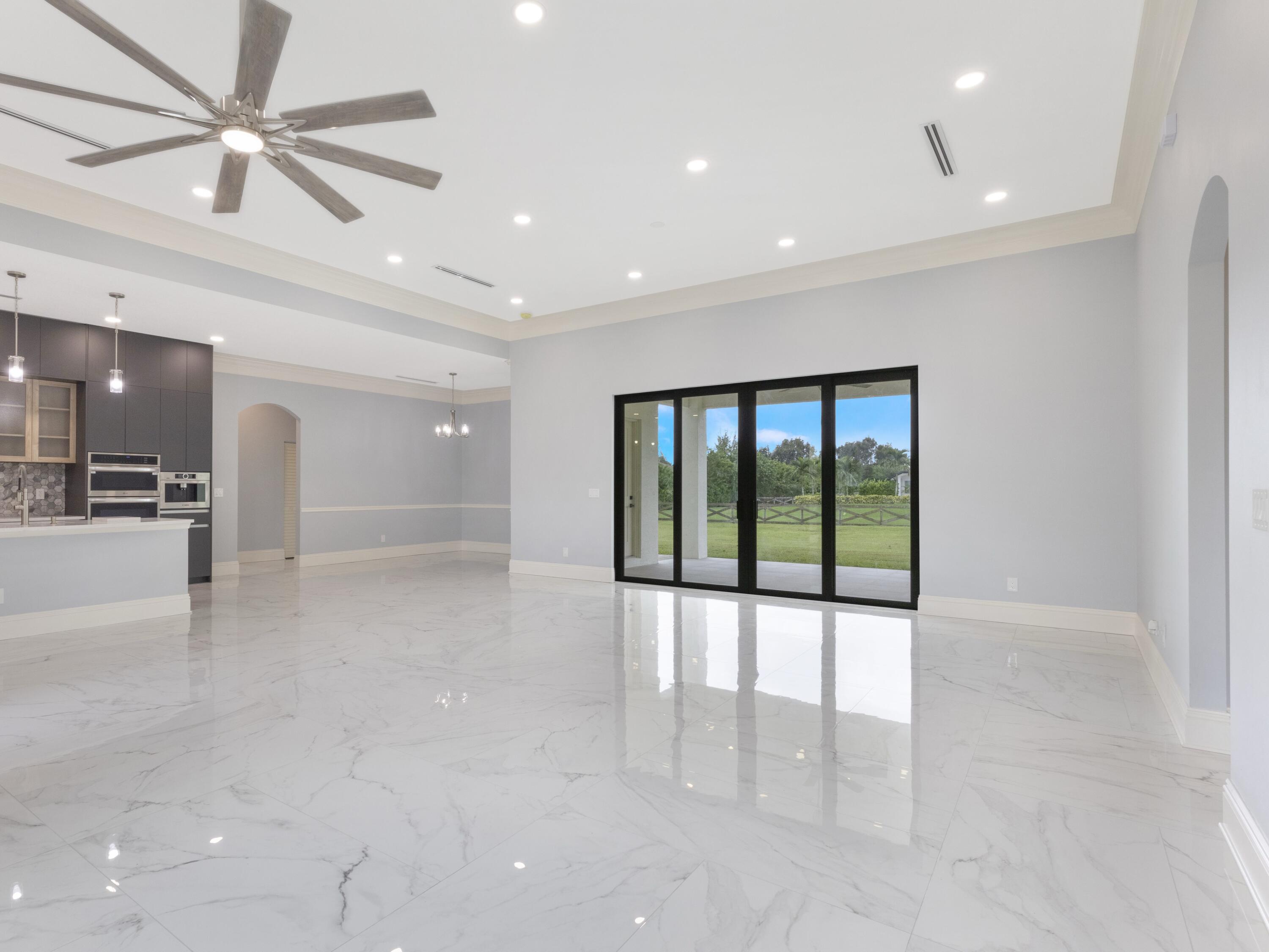17436 71st Lane North Loxahatchee, FL 33470 - Photo 22 of 50 a view of an empty room and a chandelier fan
