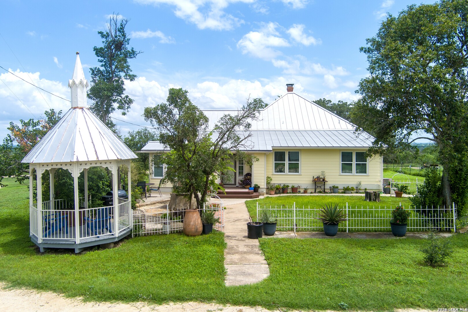 4515 Stapper Road St. Hedwig, TX 78152 - Photo 6 of 64 a front view of house with a garden and trees