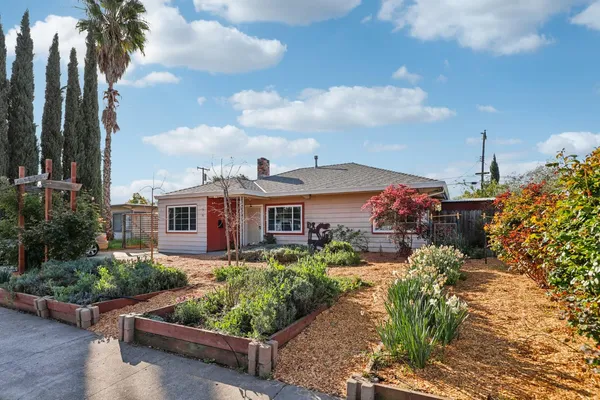 a front view of a house with a garden