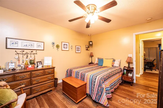 a bedroom with bed and wooden floor