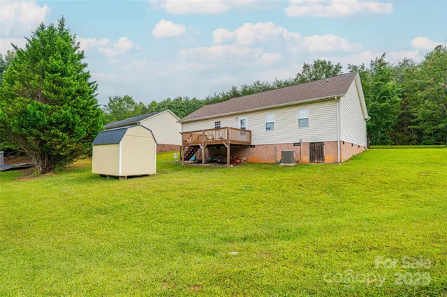 a view of a house with pool and a yard