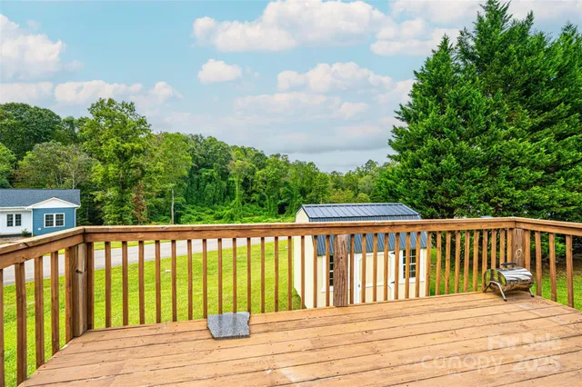 a view of wooden deck and a yard