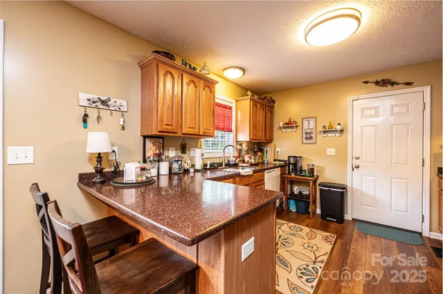 a kitchen with a table chairs stove and cabinets