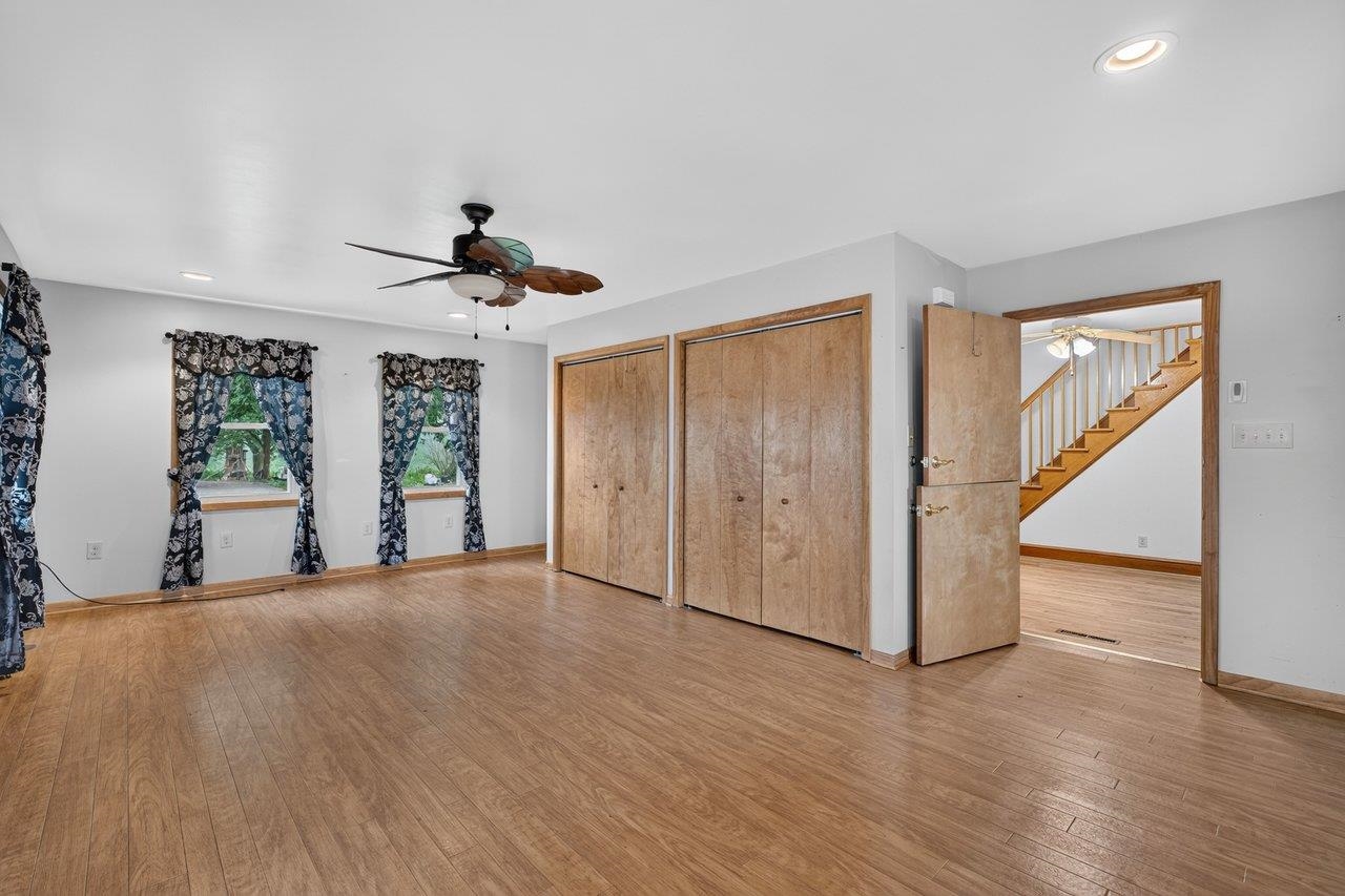 10402 Phillips Store Road Broadway, VA 22815 - Photo 20 of 68 a view of a livingroom with wooden floor and a ceiling fan