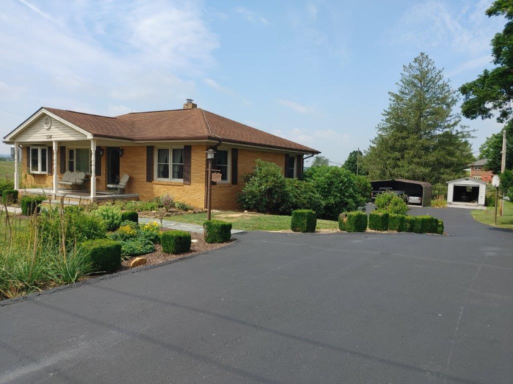 3245 Riner Road Christiansburg, VA 24073 - Photo 2 of 31 a front view of a house with a yard and garage