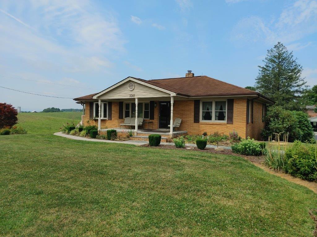 3245 Riner Road Christiansburg, VA 24073 - Photo 4 of 31 a front view of a house with a garden