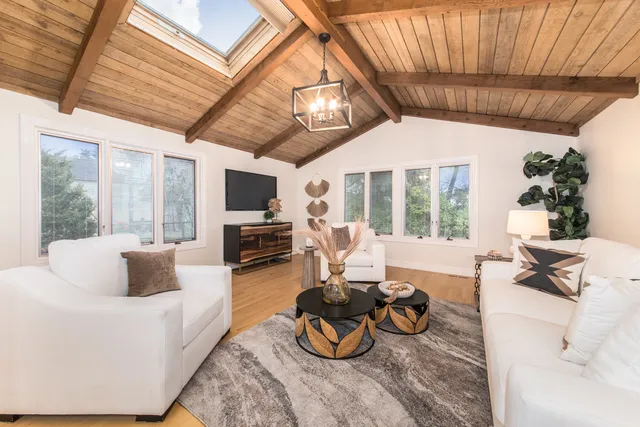 a living room with furniture fireplace and flat screen tv