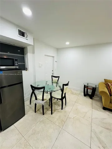 a bedroom with furniture and a rug