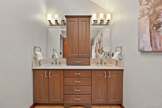 a bathroom with a granite countertop sink and a mirror