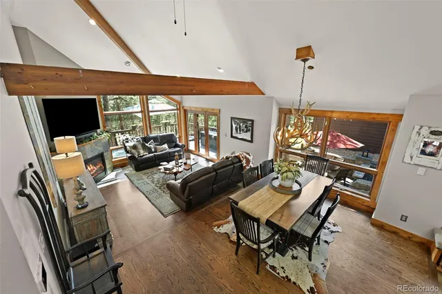 a living room with furniture a flat screen tv and a floor to ceiling window