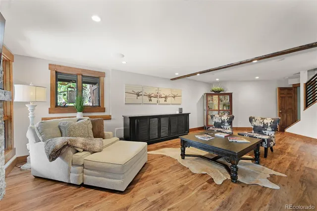 a living room with furniture and wooden floor