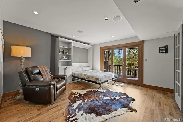 a living room with furniture rug and wooden floor
