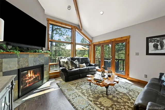 a living room with fireplace furniture and a flat screen tv