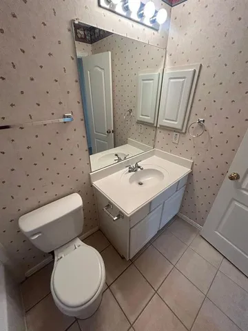 a bathroom with a sink toilet and mirror