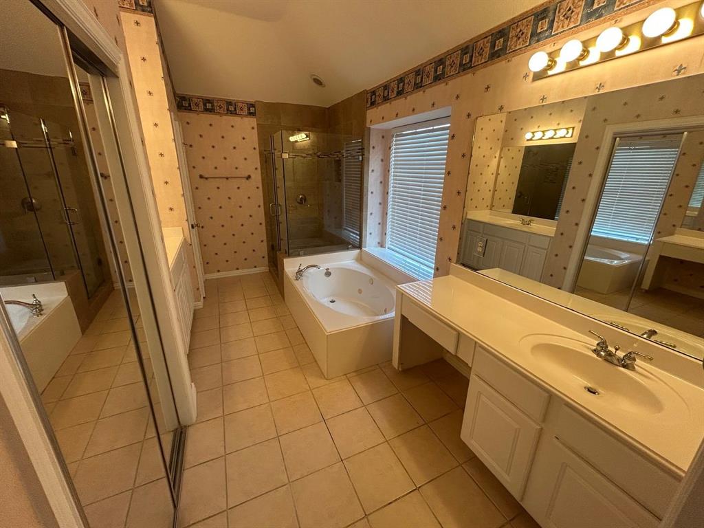 588 Southridge Way Irving, TX 75063 - Photo 18 of 26 a bathroom with a sink a toilet a mirror and vanity