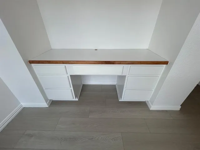 an empty room with wooden floor