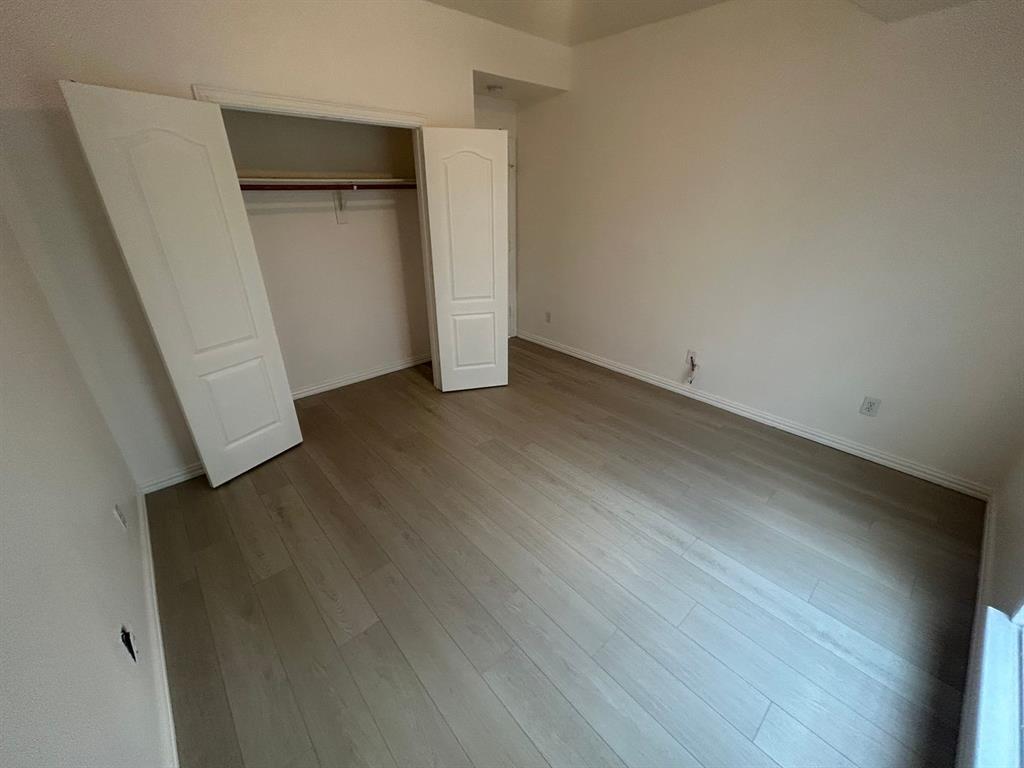 588 Southridge Way Irving, TX 75063 - Photo 21 of 26 an empty room with wooden floor and entrance