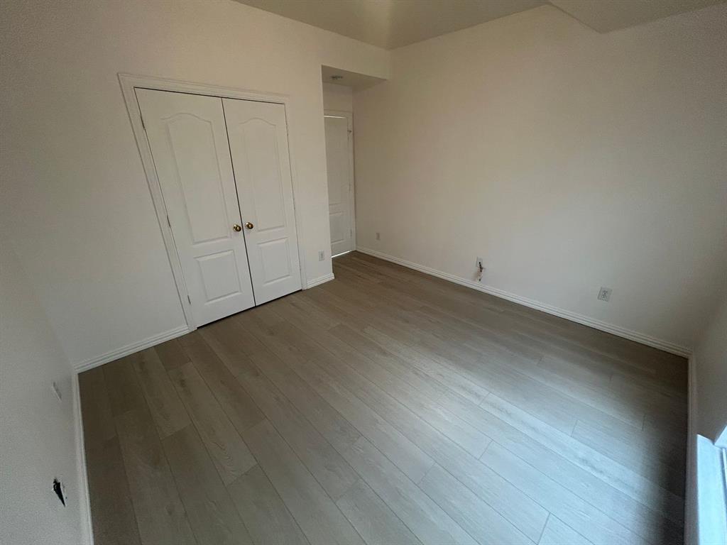 588 Southridge Way Irving, TX 75063 - Photo 22 of 26 an empty room with wooden floor