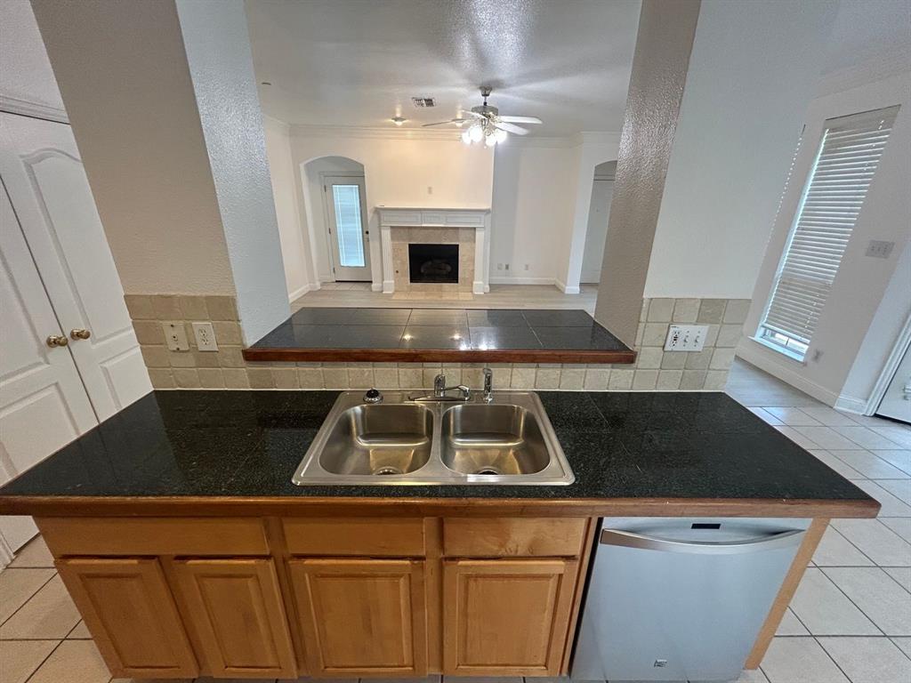588 Southridge Way Irving, TX 75063 - Photo 8 of 26 a kitchen with a sink a stove a microwave and cabinets
