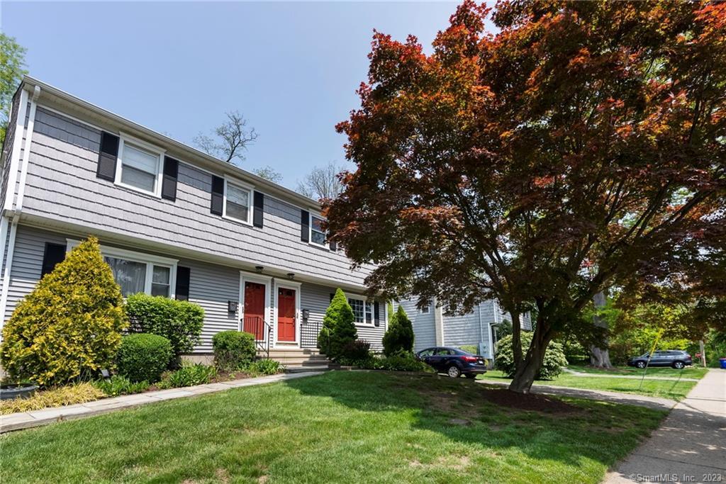 112 Rodgers Road, Unit 112 Fairfield, CT 06824 - Photo 1 of 1 a front view of a house with a yard