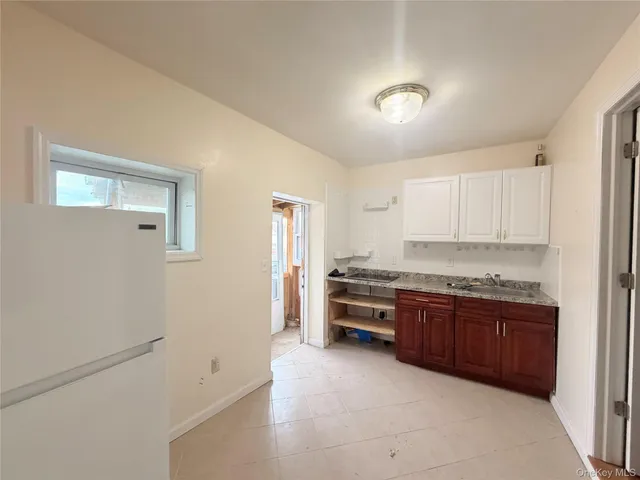 a large kitchen with stainless steel appliances granite countertop a stove and a refrigerator
