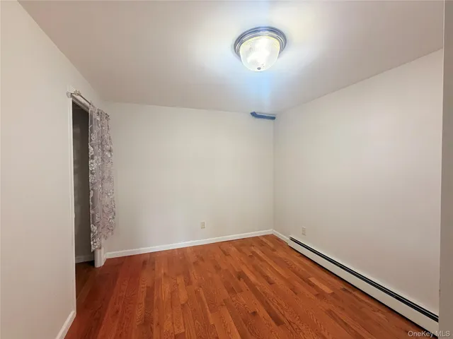 a view of a room with wooden floor