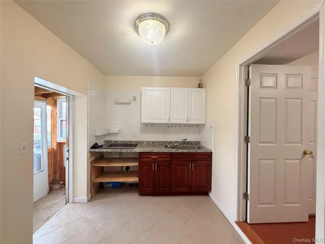 a view of kitchen with stainless steel appliances granite countertop a stove and a refrigerator
