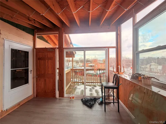 a living room with furniture and a floor to ceiling window