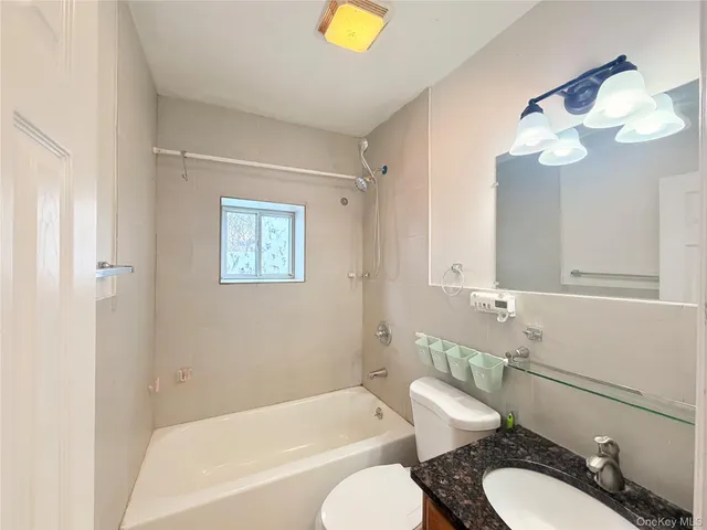 a bathroom with a toilet a sink and bathtub