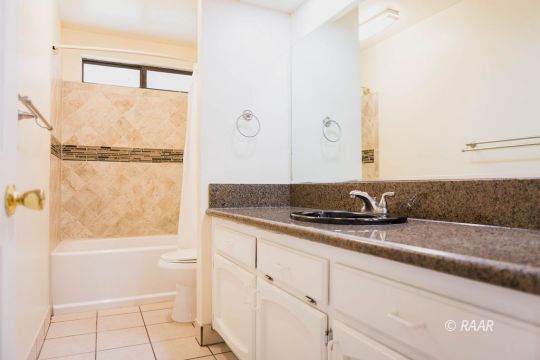 327 Henry Street Ridgecrest, CA 93555 - Photo 25 of 30 a bathroom with a granite countertop sink and a mirror