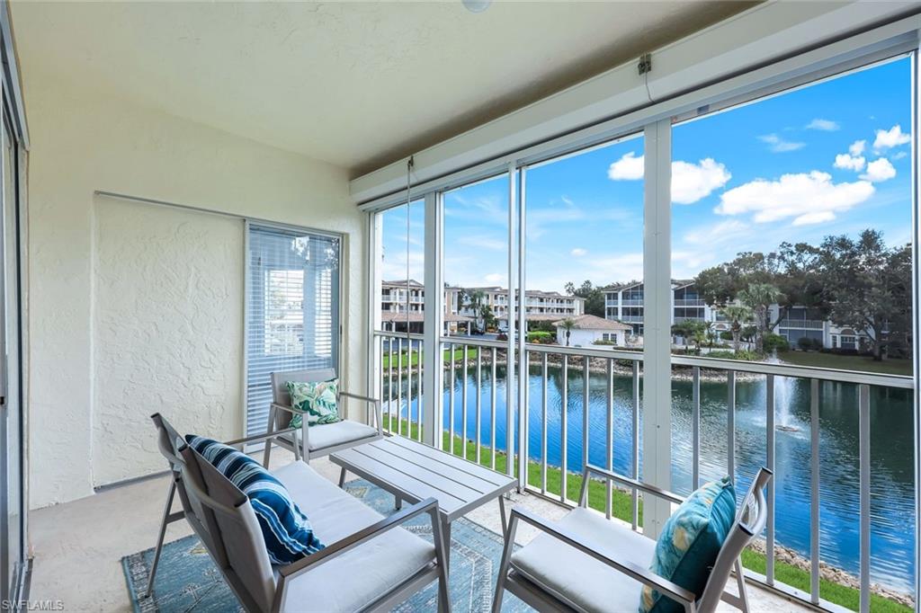 a view of a balcony with lake view and a couches