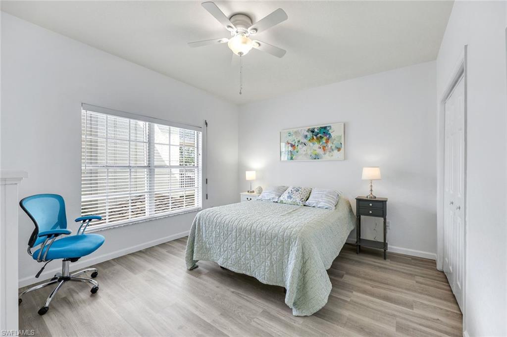 6030 Chardonnay Lane, Unit 203 Naples, FL 34119 - Photo 20 of 28 a bedroom with a bed and a window