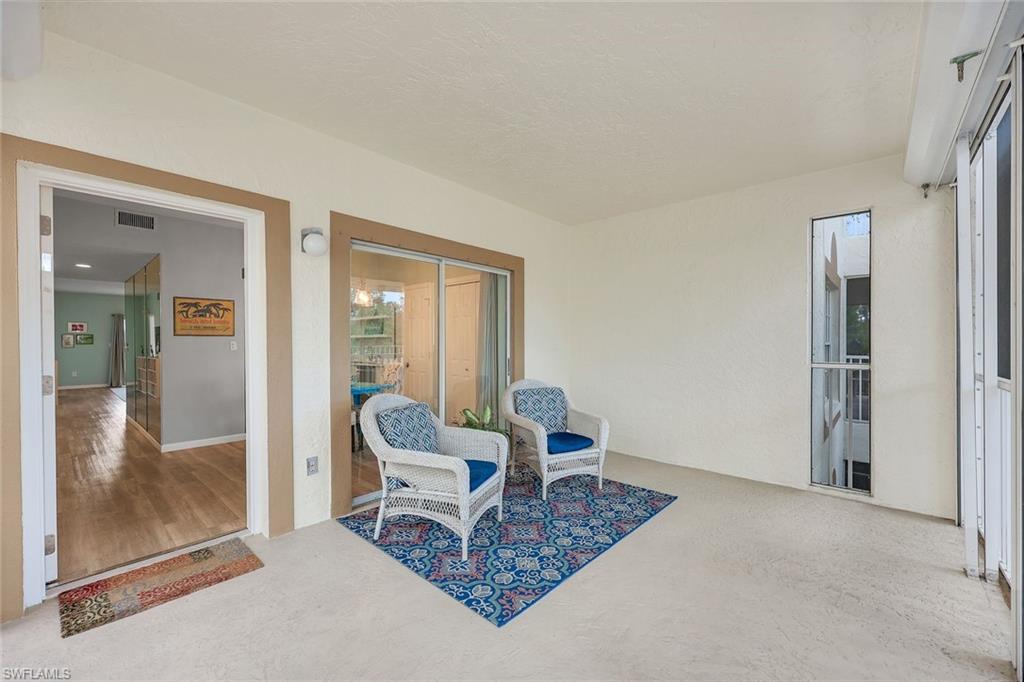 6030 Chardonnay Lane, Unit 203 Naples, FL 34119 - Photo 23 of 28 a living room with furniture and a rug