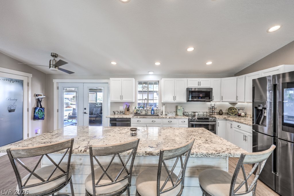 4375 Pinwheel Street Logandale, NV 89021 - Photo 10 of 52 A luminous kitchen offers extensive counter space, ideal for culinary creations and casual dining.