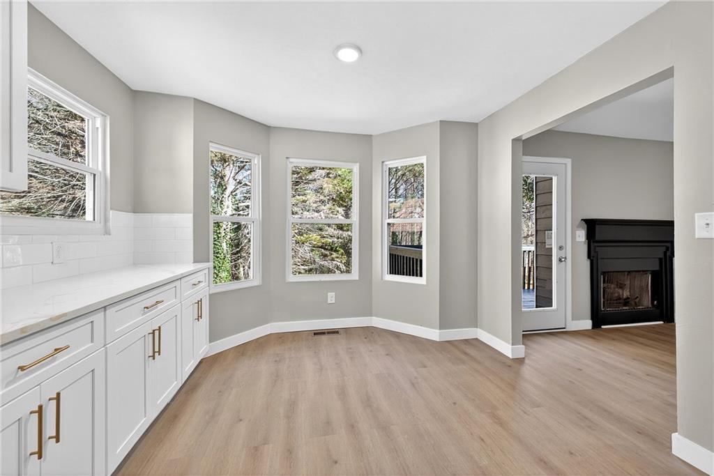2874 Fairburn Road Southwest Atlanta, GA 30331 - Photo 11 of 34 an empty room with wooden floor and windows