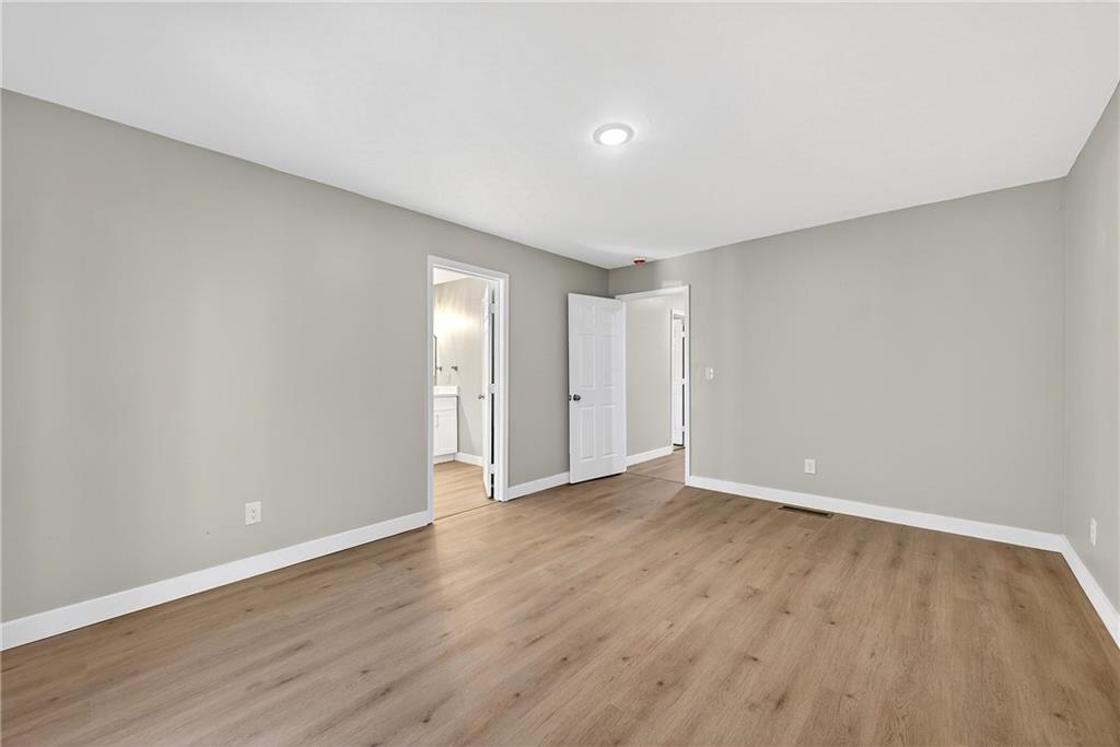 2874 Fairburn Road Southwest Atlanta, GA 30331 - Photo 13 of 34 a view of an empty room with wooden floor