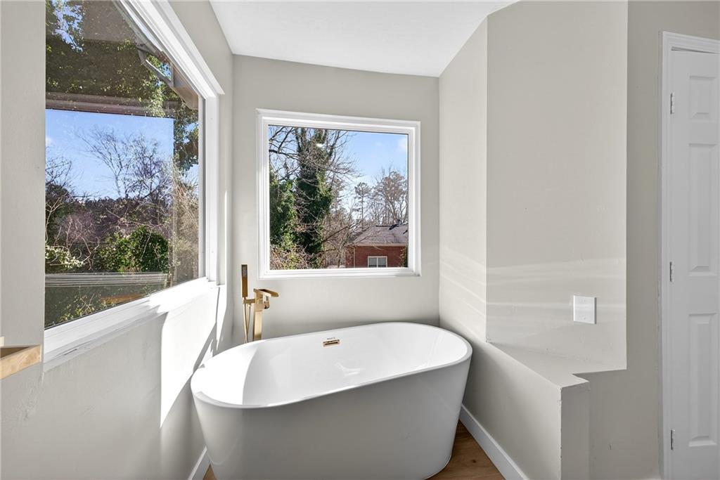 2874 Fairburn Road Southwest Atlanta, GA 30331 - Photo 16 of 34 a bathroom with a bathtub and window