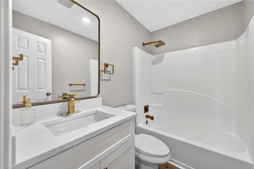 2874 Fairburn Road Southwest Atlanta, GA 30331 - Photo 18 of 34 a bathroom with a sink a toilet and shower