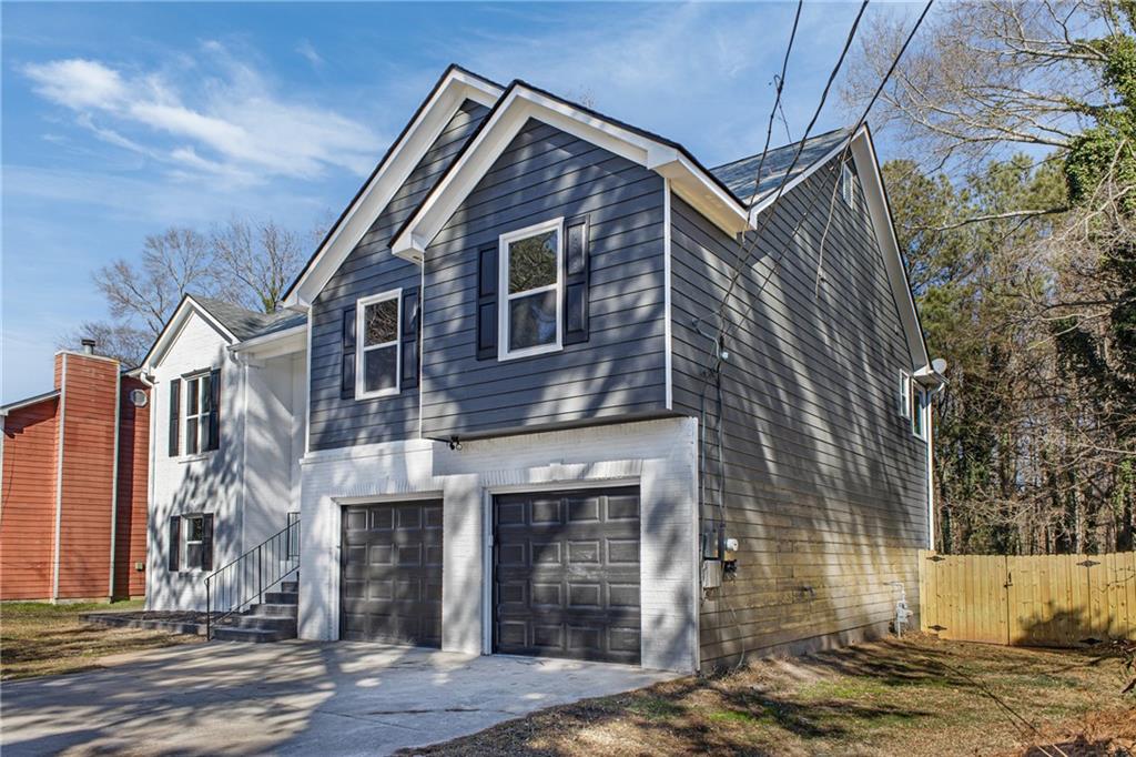 2874 Fairburn Road Southwest Atlanta, GA 30331 - Photo 2 of 34 a front view of a house with a yard